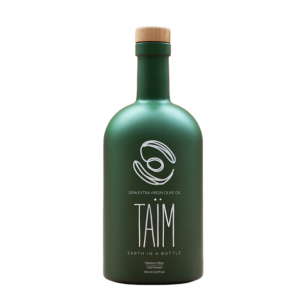 Green olive oil bottle with a wooden cap 