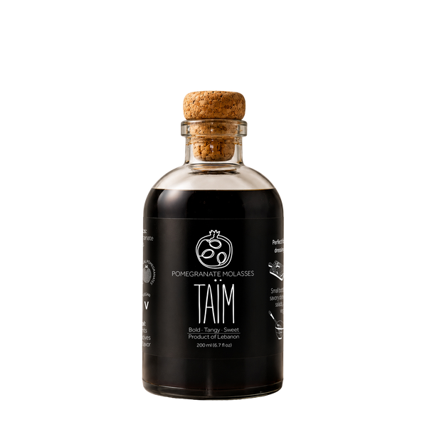 Bottle of Taim Lebanese pomegranate molasses with a cork